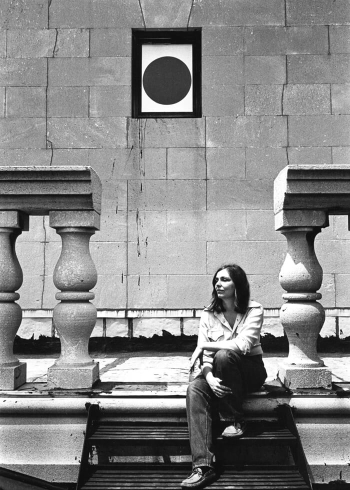 Nancy Holt with a circular window detail of her installation, Points of View at the Clocktower Gallery, New York, 1974.