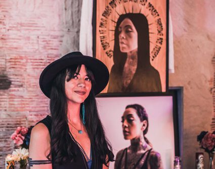 Albuquerque artist Jodie Herrera in front of artwork.