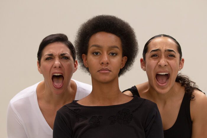 Three dancers in Keshet Dance Company's Movement for Mercy performance