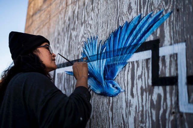 Artist Nani Chacon working on a mural.