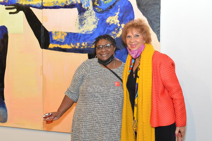 artist Rochelle Johnson in front of her painting