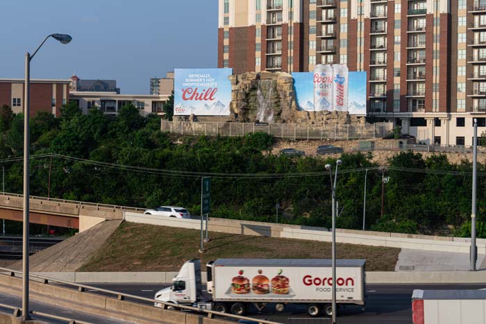 Iconic Dallas waterfall billboard flanking Interstate 35 and sentry to the entrance to the Dallas North Tollway.
