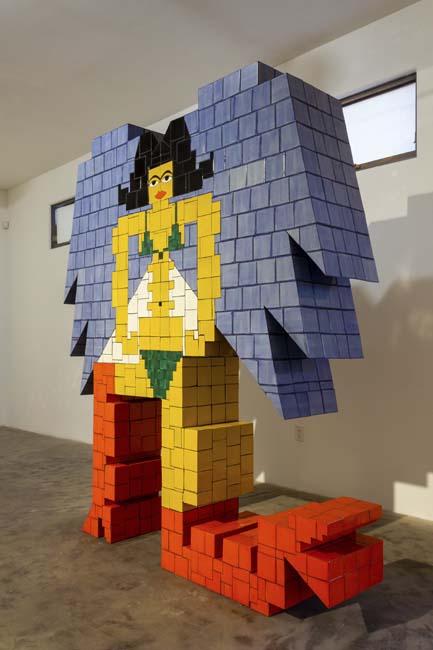 Monumental yellow tiled sculpture of a contemporary Assyrian goddess by Esther Elia.