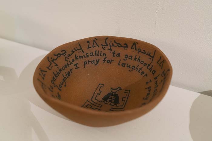Clay bowl with writing that reads, I pray for laughter.