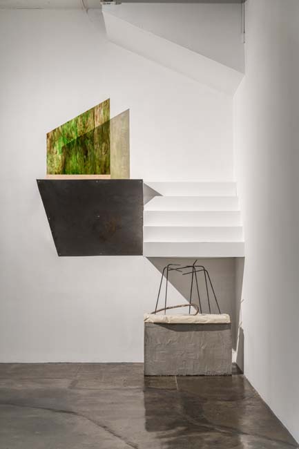 Installation with metal, glass, wood, rebar, and plaster by María José Crespo.