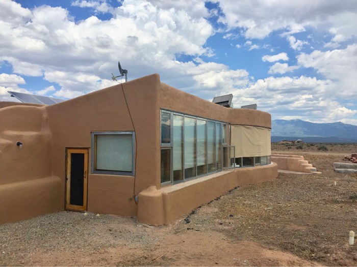 Eco Build Lab earthship exterior view during the day