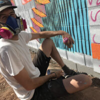 OakStreetAlley-Artist Andy Brown painting during a previous OSA mural festival in Phoenix – PhotoLynnTrimble