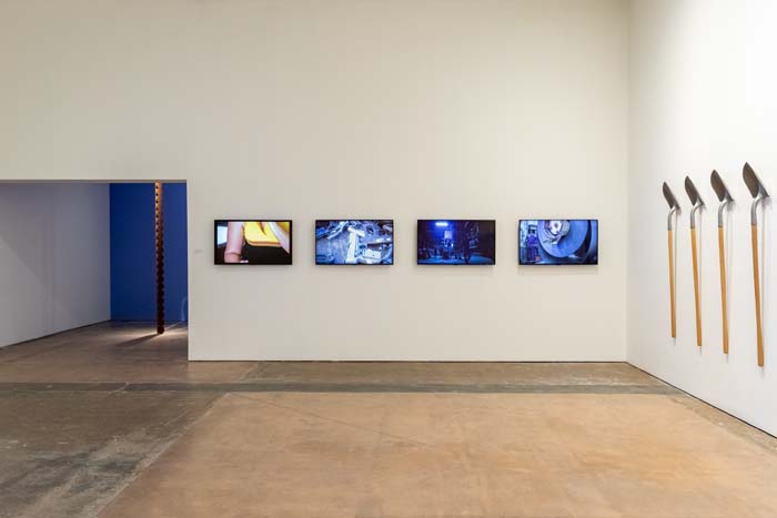 Installation view of Pedro Reyes exhibition with four video monitors.