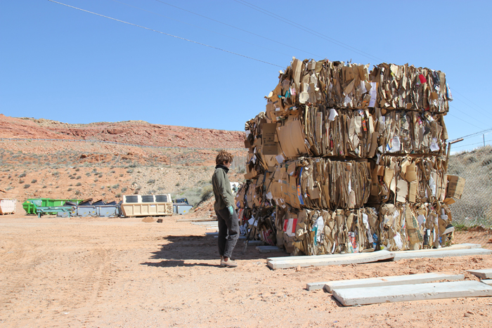 Noémie Despland-Lichtert examines bales of cardboard at the Moab Arts Reuse Residency 