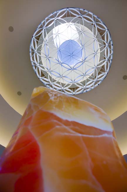 Viewed from below, an orange crystal stone and a circular oculus