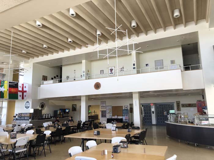 Interior of a cafeteria with a modernist white chandelier
