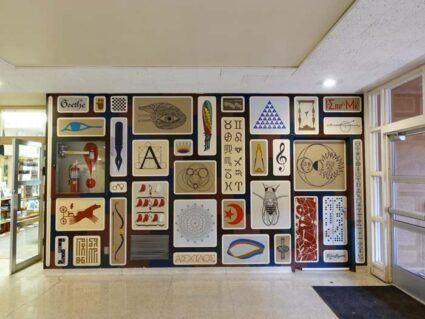 Interior mural by Alexander Girard at St. John's College with multiple blocks displaying a personal symbolic language