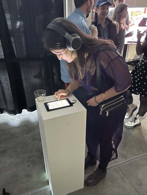 A person filling out an Intake form at Sam Grabowska's interactive installation at Understudy in Denver.