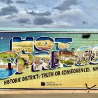 Mural in Truth or Consequences, NM with various pictures of local attractions in the bubble letters spelling "HOT SPRINGS"
