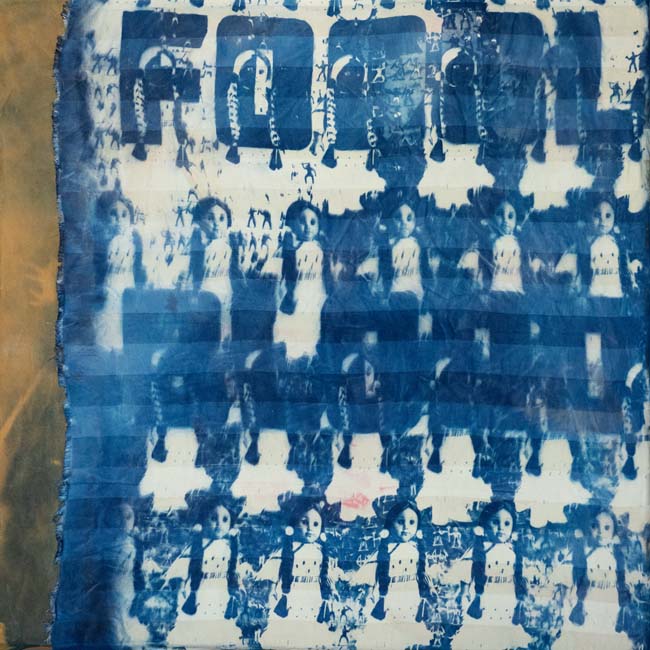 Cyanotype collage with repeated image of an American Indian doll