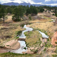 A view of Monument Creek in Colorado with two beaver dams