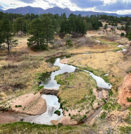 A view of Monument Creek in Colorado with two beaver dams