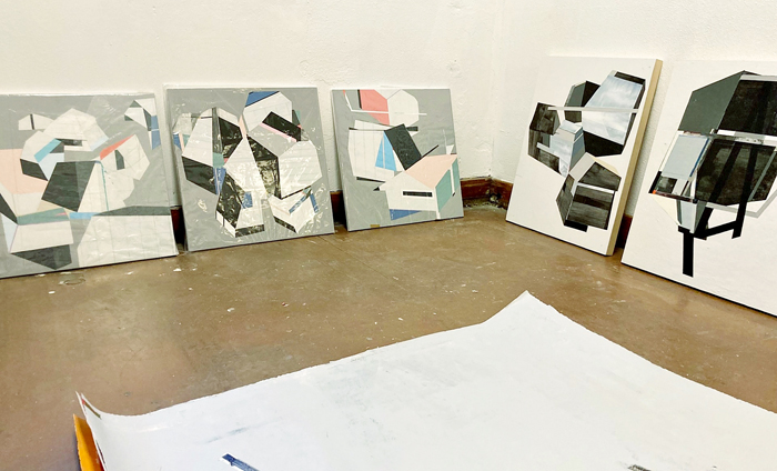 Acrylic-on-panel paintings are propped against the walls of Ramón Bonilla’s Evans School studio on May 23, 2023