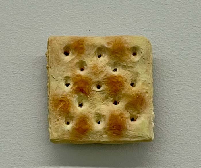 Life-size and lifelike sculpture of a saltine cracker.