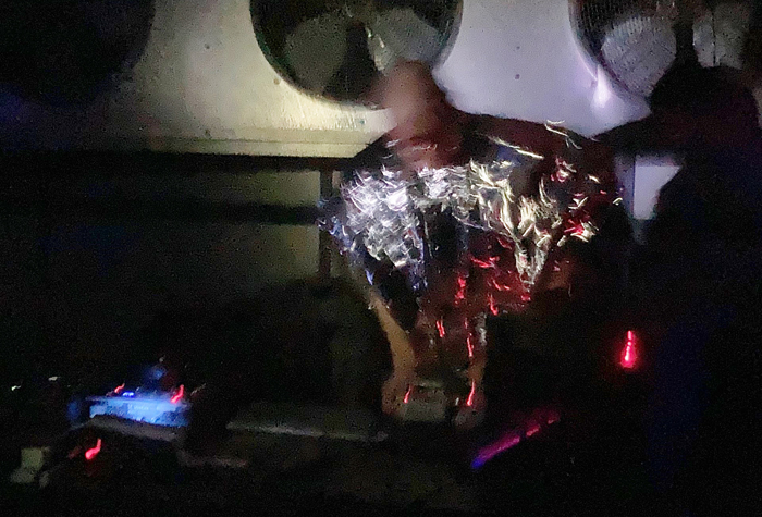 Ben Coleman performs a noise set in a Mylar cape at the iMAC building in Denver