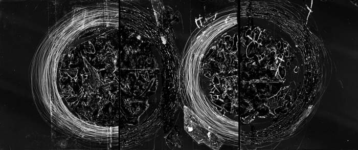 Abstract black and white triptych photogram with two scratched circular forms by Claire A. Warden.