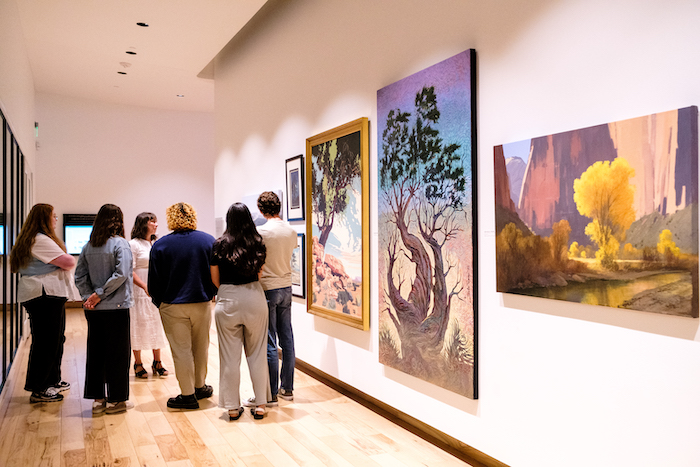 Visitors receive a tour of Reaching for the Sky: Trees in the Works of Jimmie Jones & Other Artists, Near & Far