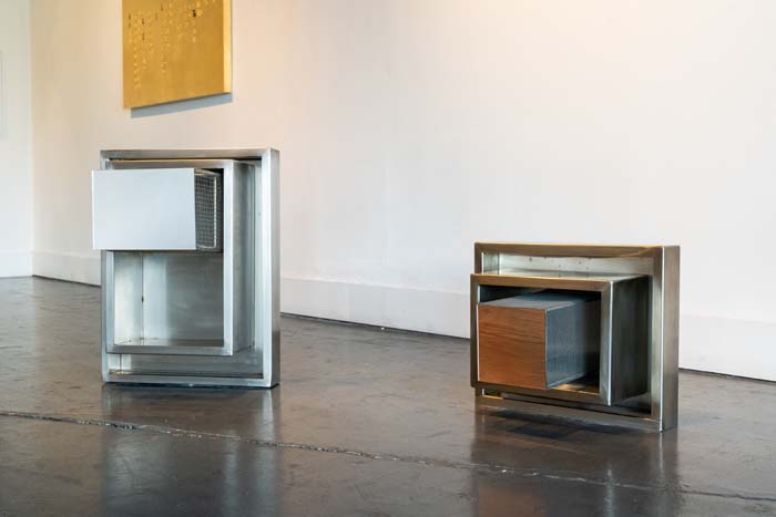 Two boxy sculptures made of mirror, stainless steel, and mesh in the exhibition I am Not Your Mexican.