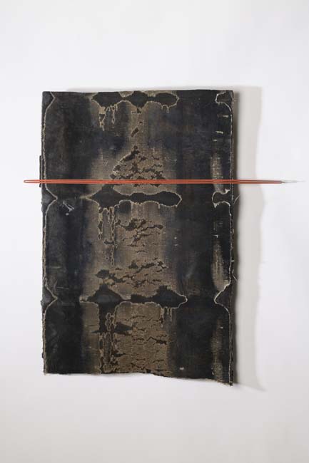 Black mixed media work with patches of brown flaking paint bisected by a red horizontal line.