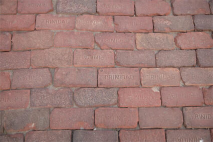 Wall of bricks with the word "Trinidad" on each.