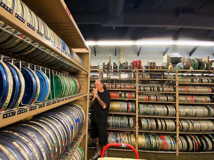 Bryan Konefsky in the midst of Basement Films's massive collection of film reels