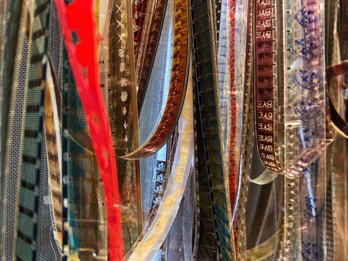 Detail view of experimental filmstrips hanging loose.