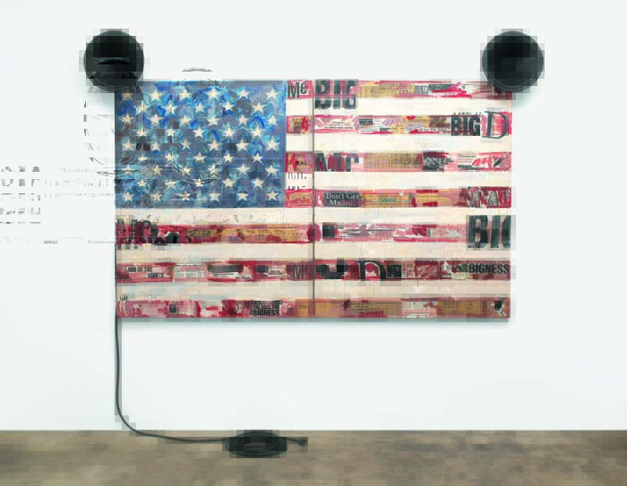 Painting of an American flag with newsprint underneath and two loudspeakers on either side.