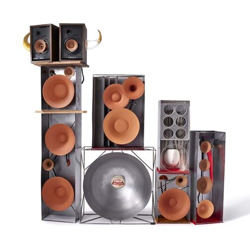 Four stacks of speakers made of ceramic and steel of various sizes.