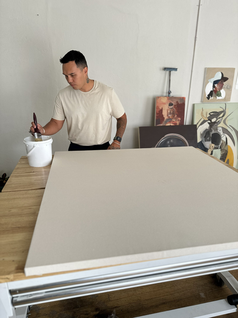 George Alexander works on a canvas