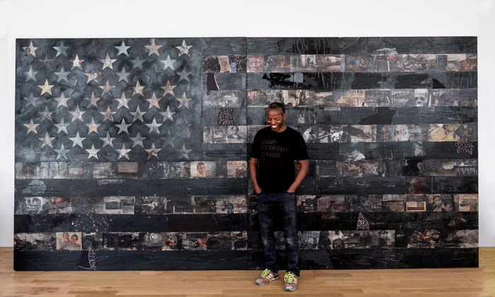 Cey Adams stands in front of his 2018 work All American (Black Flag No. 4)
