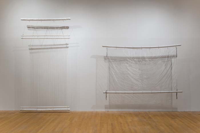 Two works by Eric Paul Riege of looms and woven blankets made of transparent fibers.