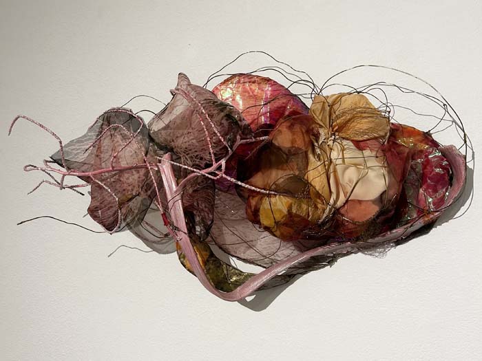 Mixed media sculpture with wire, palm inflorescence, silk, and other materials.