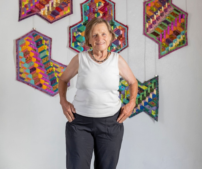 Rebecca Speakes with quilted accent pieces from Dimensionality: Quilts of a Different Stripe