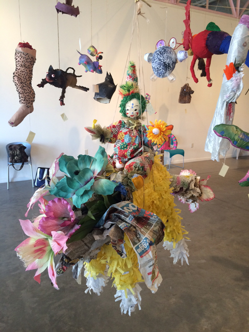Beatrice Moore's Ashes to Ashes piñata (foreground) on display at the 2015 Mutant Piñata Show