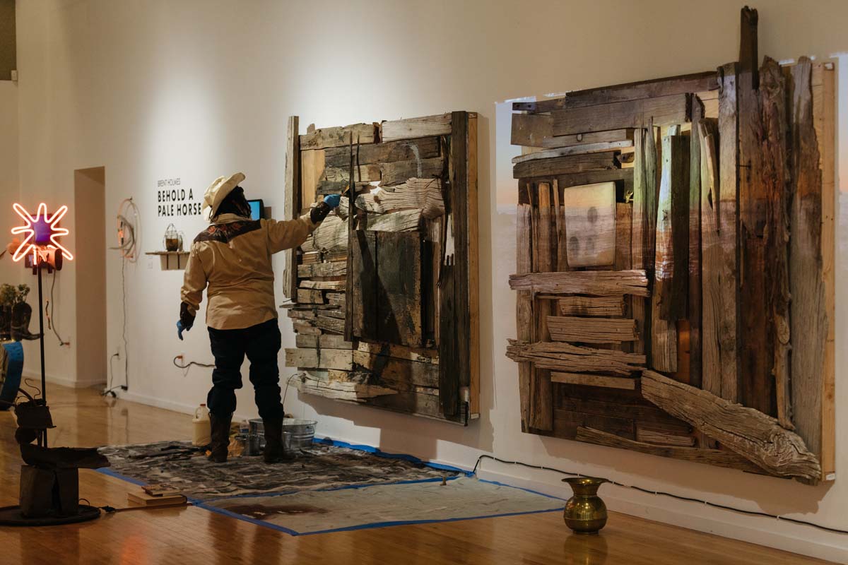 Artist Brent Holmes installing his exhibition at the Marjorie Barrick Museum in Las Vegas.