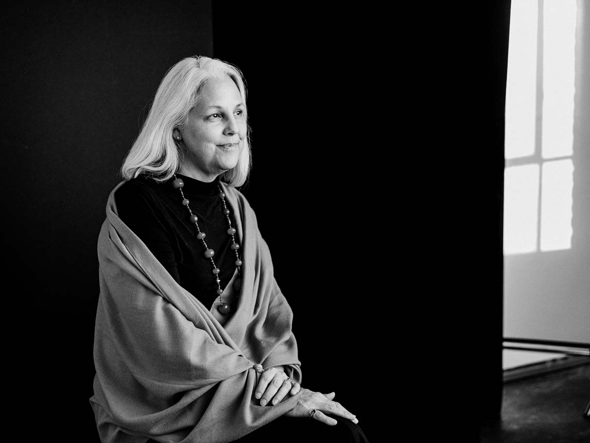Black and white portrait of Anne Elise Urrutia wearing a shawl and looking to the right.