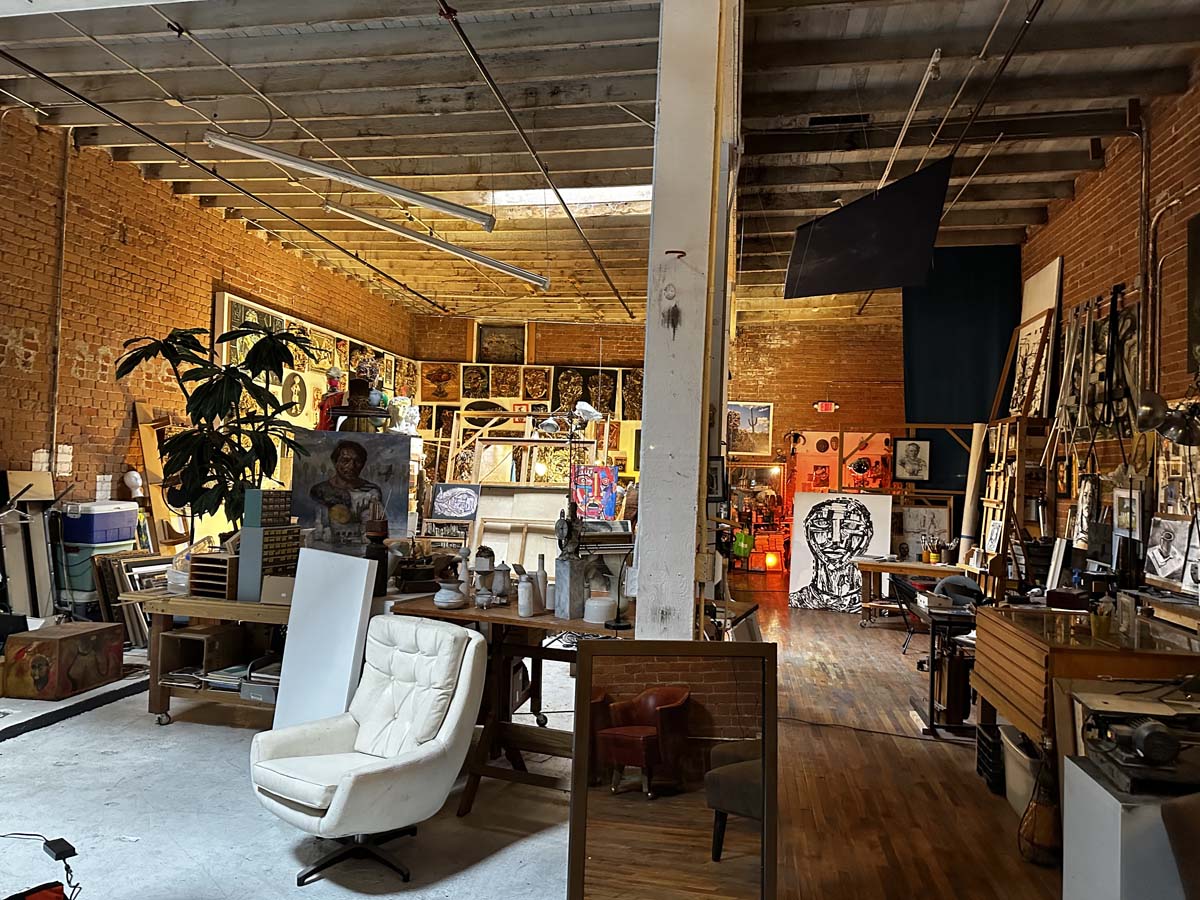 Interior of artist Nick Georgiou's studio, a spacious, high-ceilinged warehouse space.