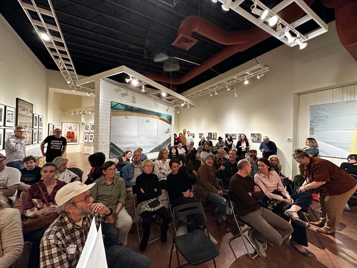 A seated crowd in an art gallery in Tucson, Arizona.
