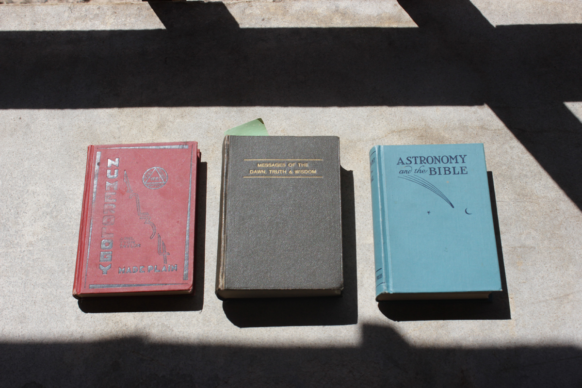A sample of three ofMarie Ogden’s books demonstrate her spiritual beliefs—a blend of astrology, numerology, and Christianity. Photography by Emily Arntsen.