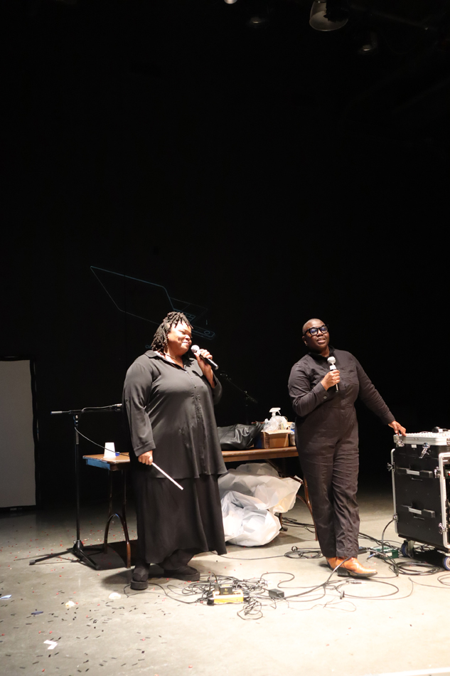 Li Harris and Autumn Knight hold microphones during their performance