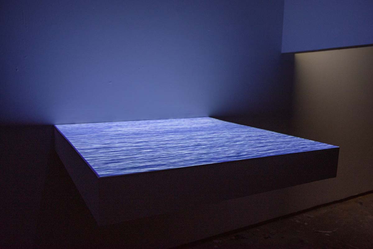 A horizontal panel with a video projection of water.