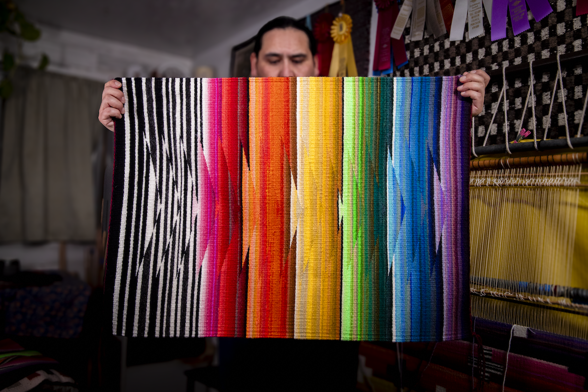 Venancio Aragon holding the piece Color Wave