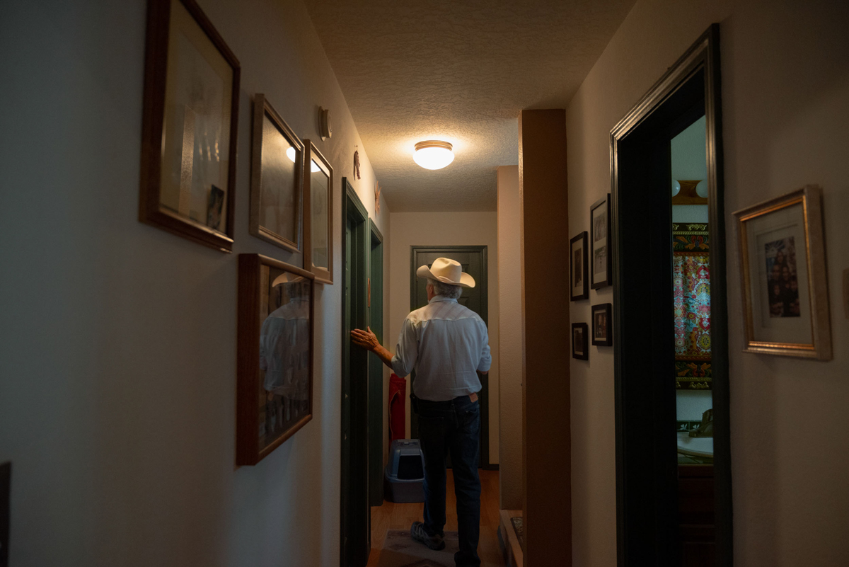 A photo by Sofie Hecht of Paul Pino in the hallway of his home