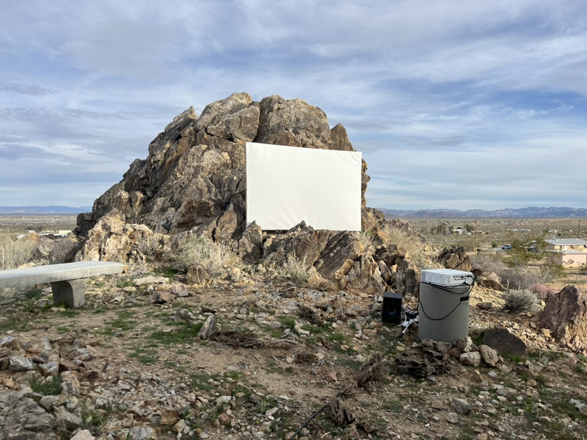 Anne Senstad’s video art piece projected on a small screen, leaning against a rock at the High Desert Art Fair