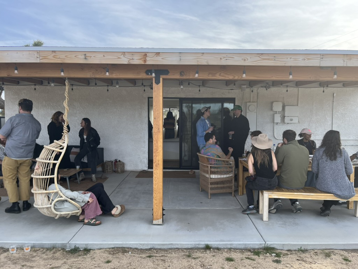 Fairgoers drink and talk on the patio of the Assembly House at the High Desert Art Fair